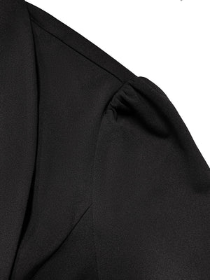 Black blazer with draped front and sculpted silhouette featuring gathered sleeve detail.