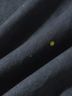 Grey sweatpants with yellow ink-splash detail, loose fit, comfortable casual activewear.
