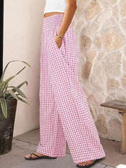 Pink plaid gingham maternity pants with smocked waistband and wide legs.