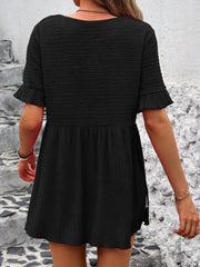 Black textured babydoll blouse with flutter sleeves and smocked waist detail.
