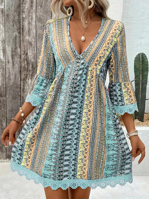 Bohemian printed v-neck dress with bell sleeves and lace trim in lake blue.