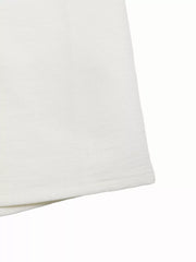 White wide-leg pants with subtle texture and crochet detail.