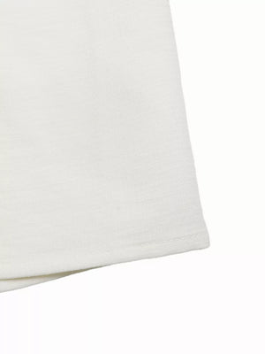 White wide-leg pants with subtle texture and crochet detail.