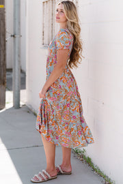 Floral smocked bodice tiered midi dress with short sleeves and a flowy skirt.