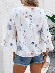 White floral bell sleeve blouse with delicate watercolor floral print and lace trim detail.
