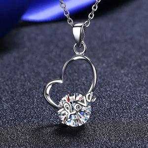 Silver heart halo pendant necklace with a round clear crystal and the word "love" inscribed.