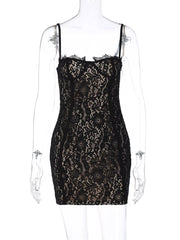 Black lace mini dress with spaghetti straps and scalloped lace trim.