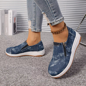 Blue denim slip-on sneakers with side zipper and chunky white sole