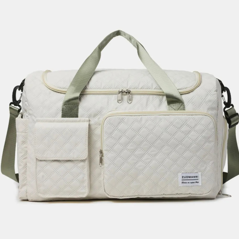 Quilted duffel bag in white with olive green accents and multiple pockets.