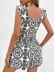 Black and white printed crop top with ruffle sleeves and matching shorts.