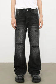 Distressed dark flare jeans with bleach wash and ripped details
