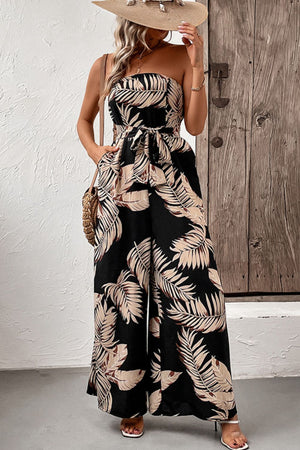 Black bandeau jumpsuit with tropical leaf print and tie waist.