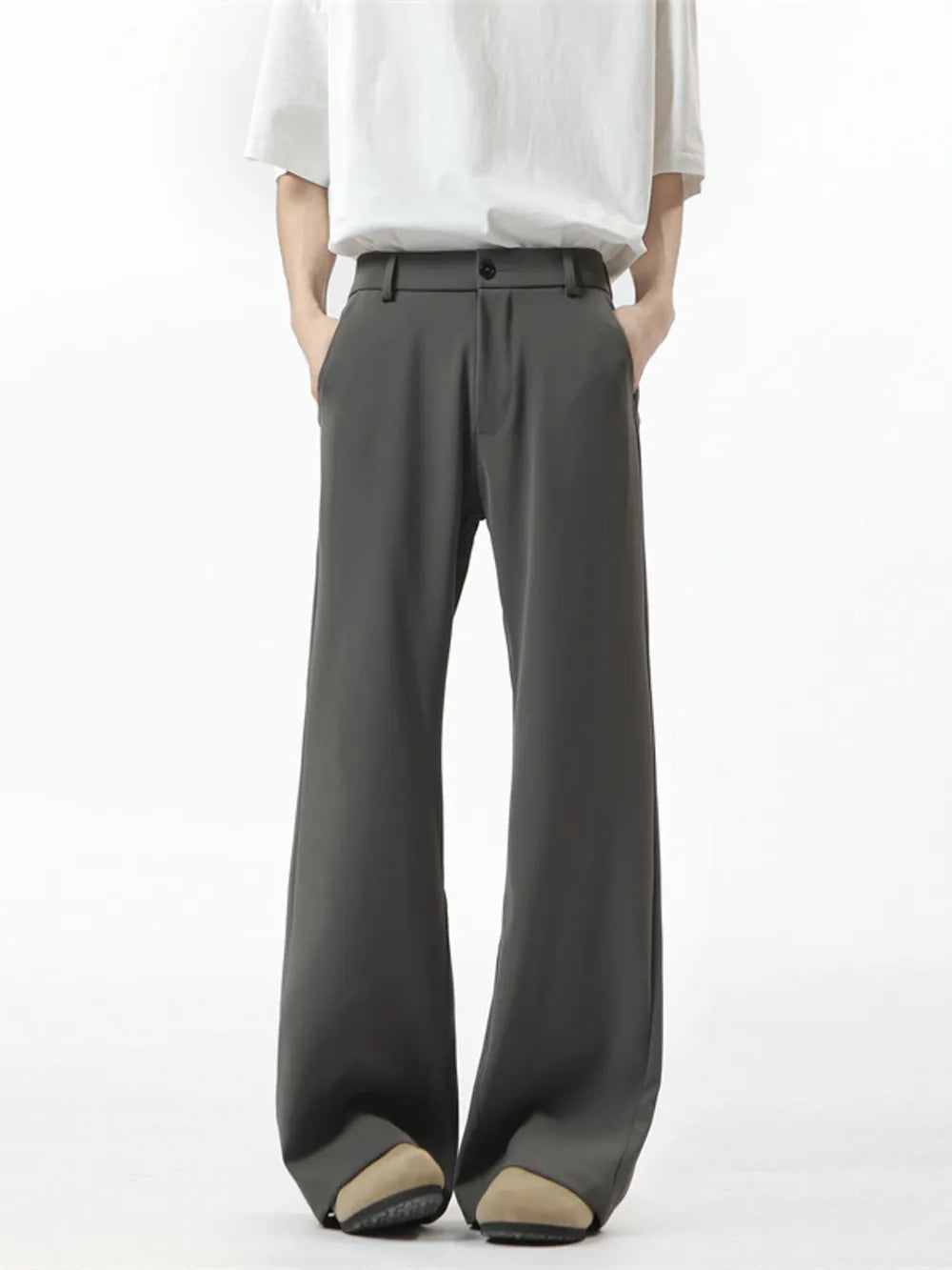 Men's dark gray sweatpants with a relaxed fit and wide leg, styled with a white t-shirt.