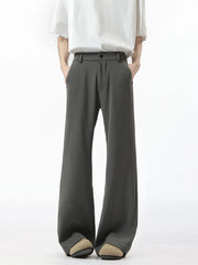 Men's dark gray sweatpants with a relaxed fit and wide leg, styled with a white t-shirt.