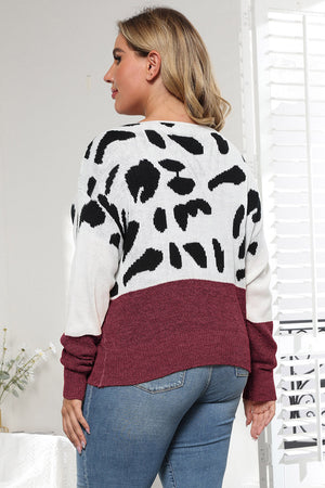 Dalmatian print colorblock knit sweater in black and wine with crew neck.