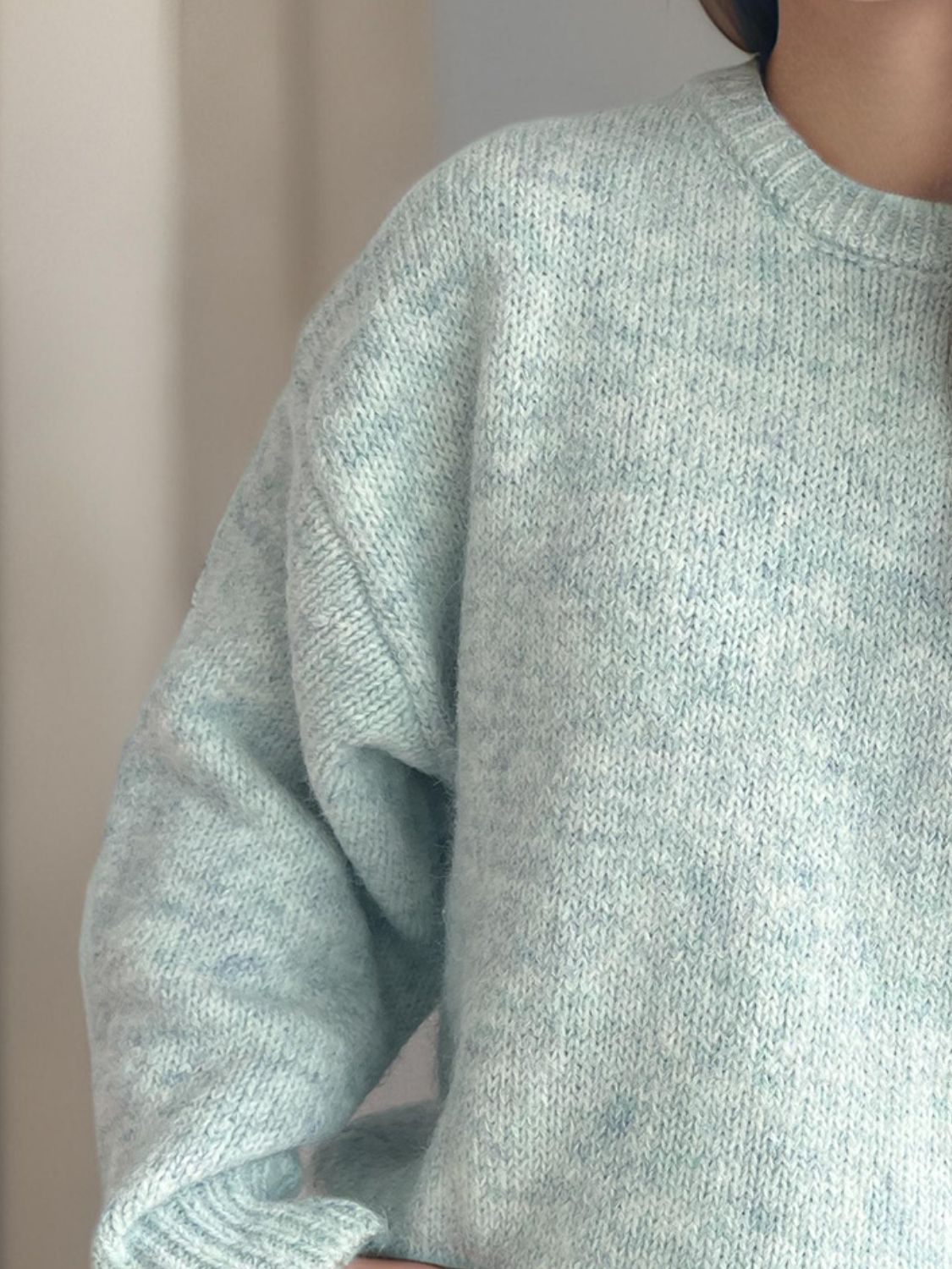 Light green oversized crewneck sweater with textured knit and speckled detail.