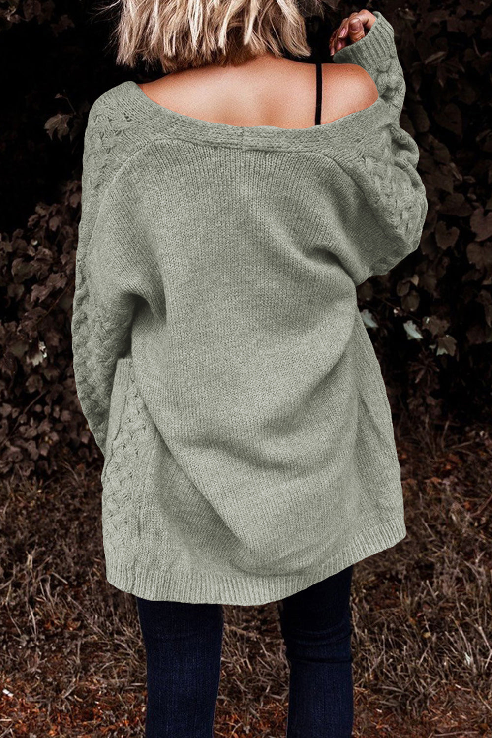 Light gray open-knit cardigan with cable knit sleeves and a relaxed fit.
