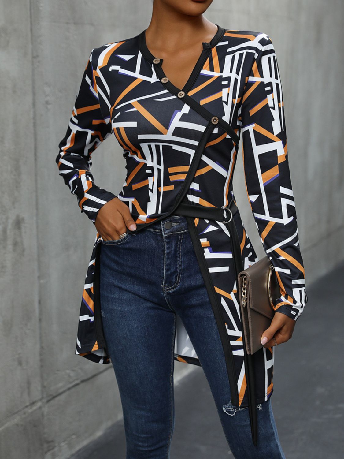 Black geometric print asymmetric blouse with decorative buttons and a V-neck.