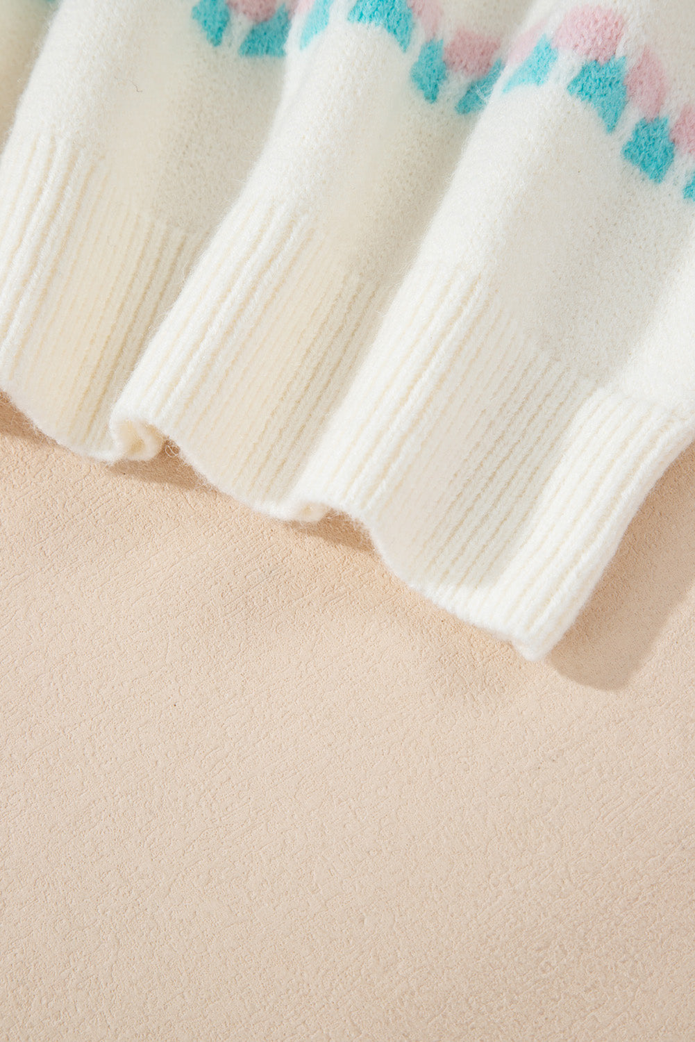 White acrylic knit sweater with a textured tree motif pattern and ribbed cuffs.