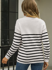 White and black striped acrylic sweater with button detail on shoulder.
