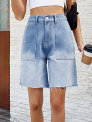 Light blue faded denim carpenter shorts with raw hem and large front pockets.