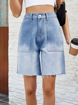 Light blue faded denim carpenter shorts with raw hem and large front pockets.