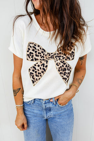 White cotton t-shirt with crew neck and leopard print bow graphic detail.