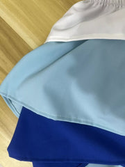 Chic layered ruffle two-piece set with color block detail in white, light blue, and royal blue.
