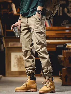 Men's khaki cargo joggers with drawstring and cuffed ankles.