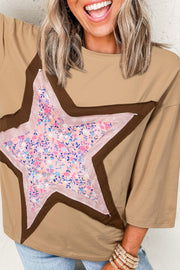 Tan cotton tee with a floral star patchwork detail and brown trim.