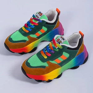 Rainbow gradient chunky sneakers with green mesh and brown suede, featuring rainbow laces and soles.