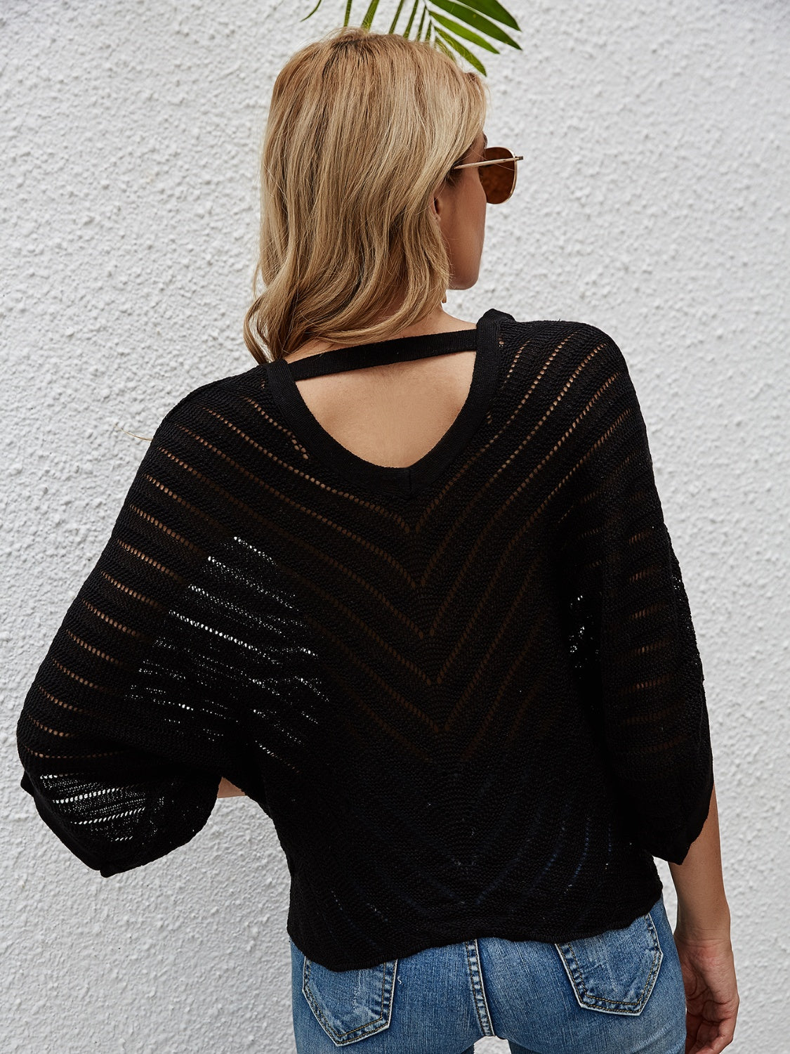 Black chevron knit tie-front cover-up with batwing sleeves and cutout detail.
