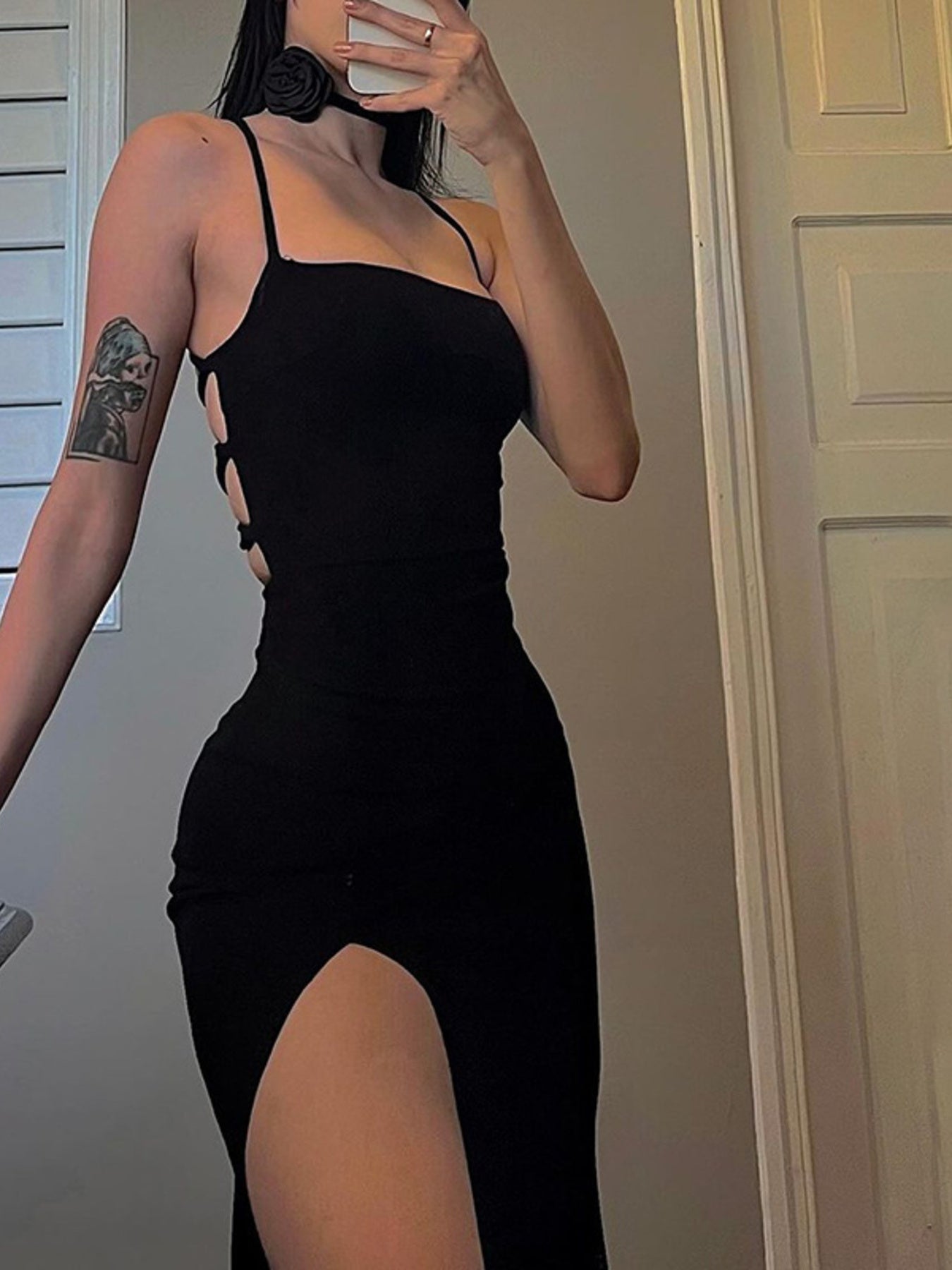 Black backless bodycon dress with spaghetti straps and high slit.
