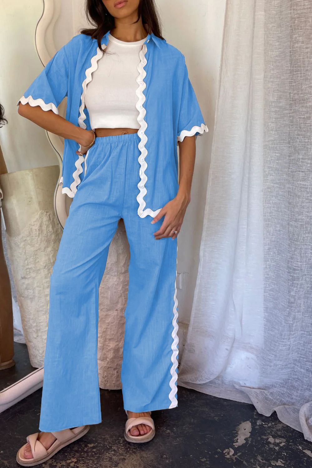Sky blue co-ord set with scalloped trim, featuring a short sleeve button-up shirt and wide-leg pants.