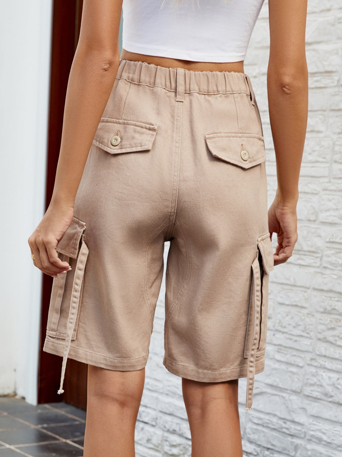 Khaki cargo pocket denim bermuda shorts with buttoned back pockets and drawstring detail.