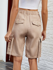 Khaki cargo pocket denim bermuda shorts with buttoned back pockets and drawstring detail.