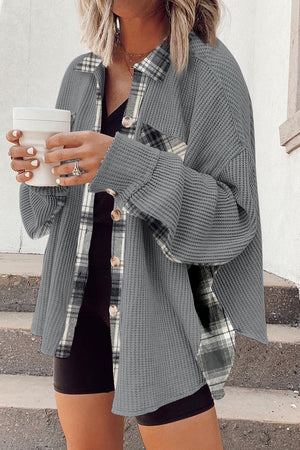 Light gray waffle knit overshirt with plaid trim and button front, styled casually.