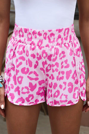 Pink leopard print shorts with elastic waistband and scalloped hem
