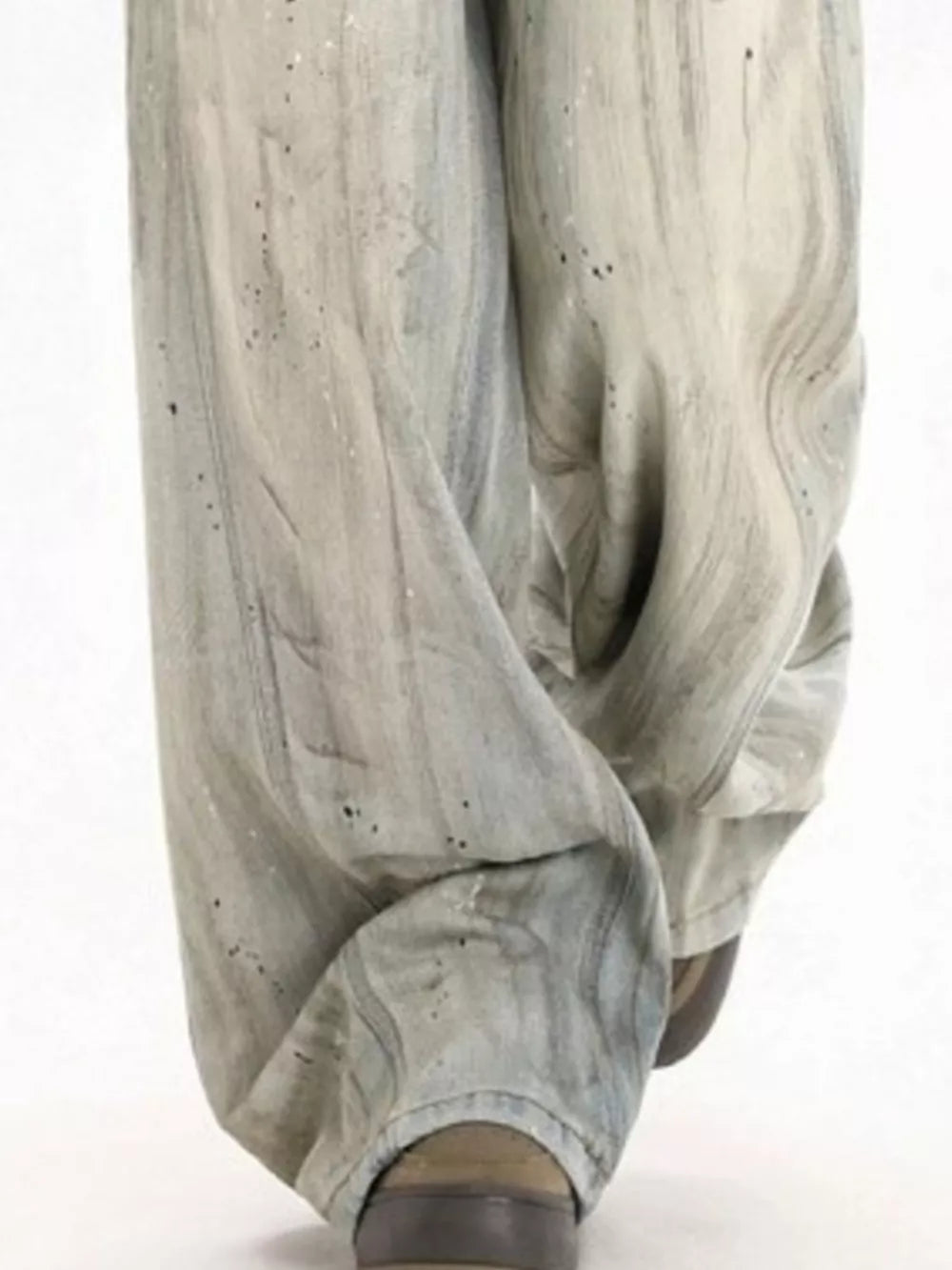 Light vintage wash wide-leg denim trousers with distressed details and paint splatters.
