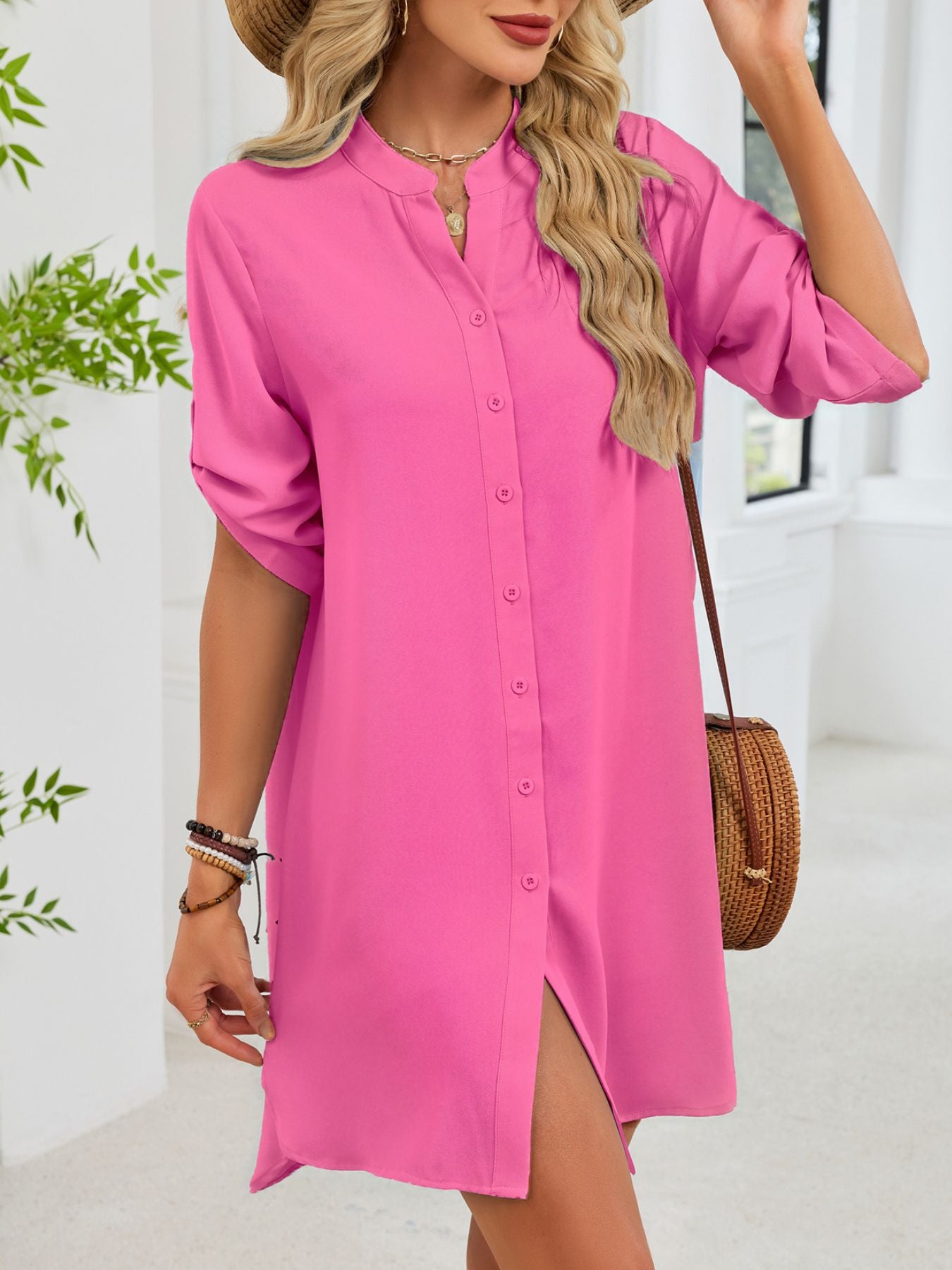 Fuchsia pink button-down shirt dress with band collar and rolled sleeves.