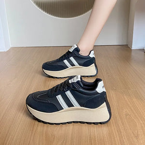 Black retro stripe platform trainers with white accents and a beige sole.