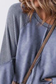 Dusty Blue waffle knit raglan sweatshirt with contrast sleeves and raw hem details.