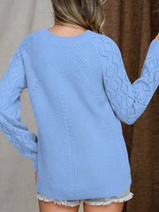 Blue diamond-cut raglan knit sweater with textured sleeves and neckline.