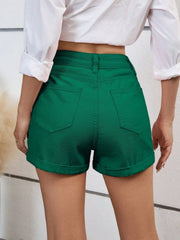 Dark green denim high-waist shorts with cuffed hems and back pockets.