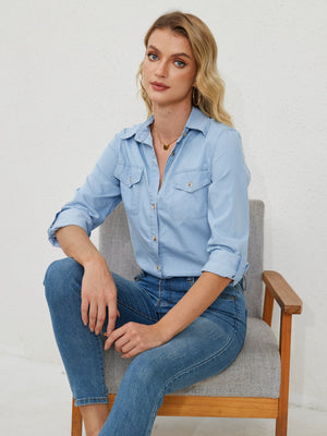 Light wash denim utility shirt with button front and chest pockets, cuffed sleeves.