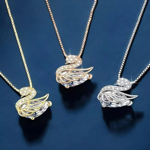 Swan pendant necklaces in gold, silver, and rose gold with crystal accents.