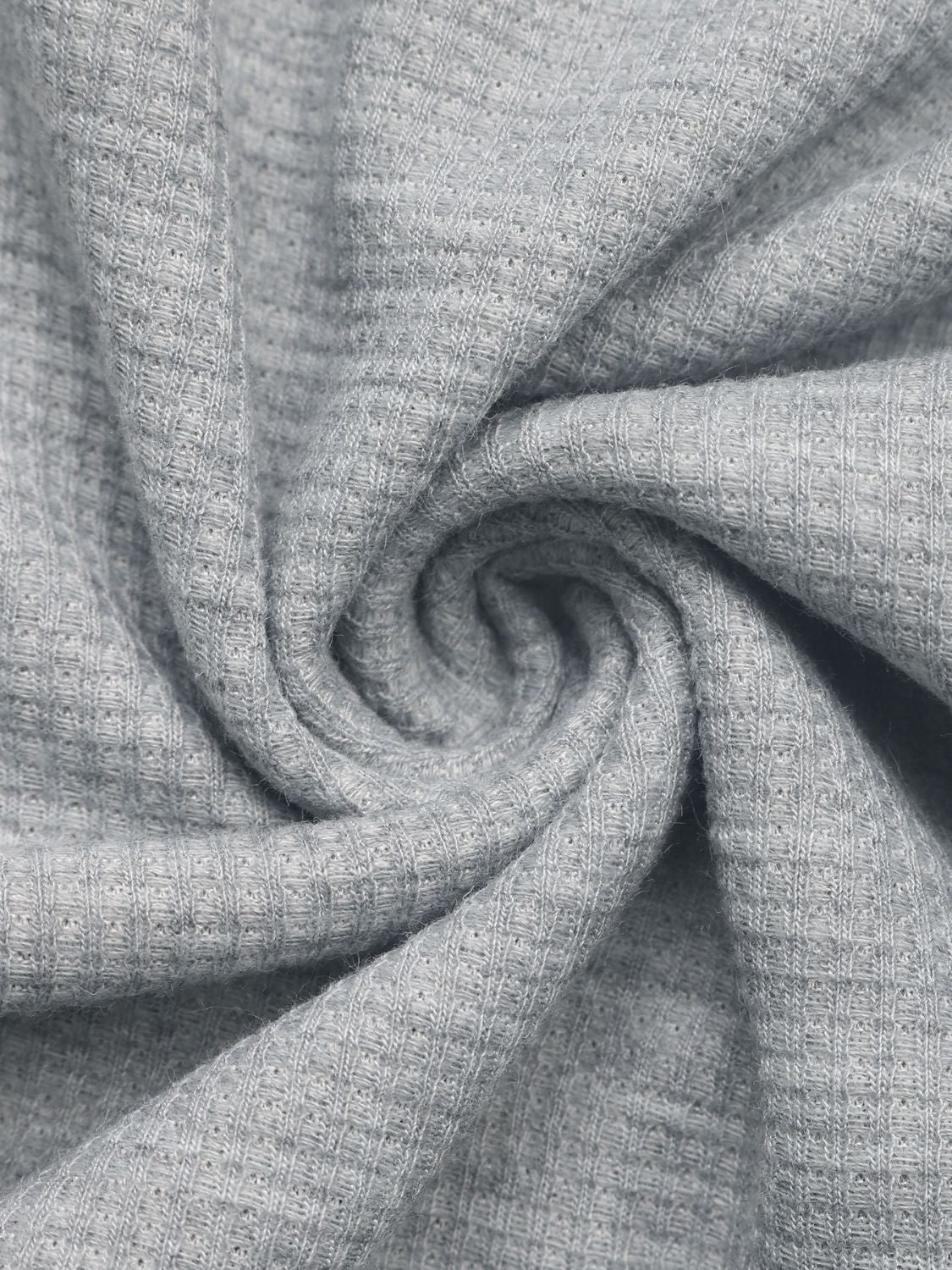 Gray waffle knit fabric detail of a button-down hooded pullover.