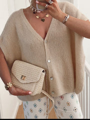 Khaki cap sleeve mohair blend cardigan with V-neck and button front, styled with a straw crossbody bag.
