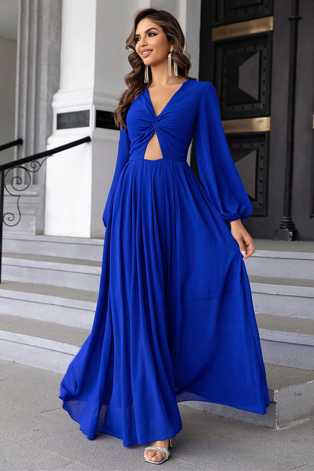 Royal blue maxi dress with twisted bodice cutout and long balloon sleeves.