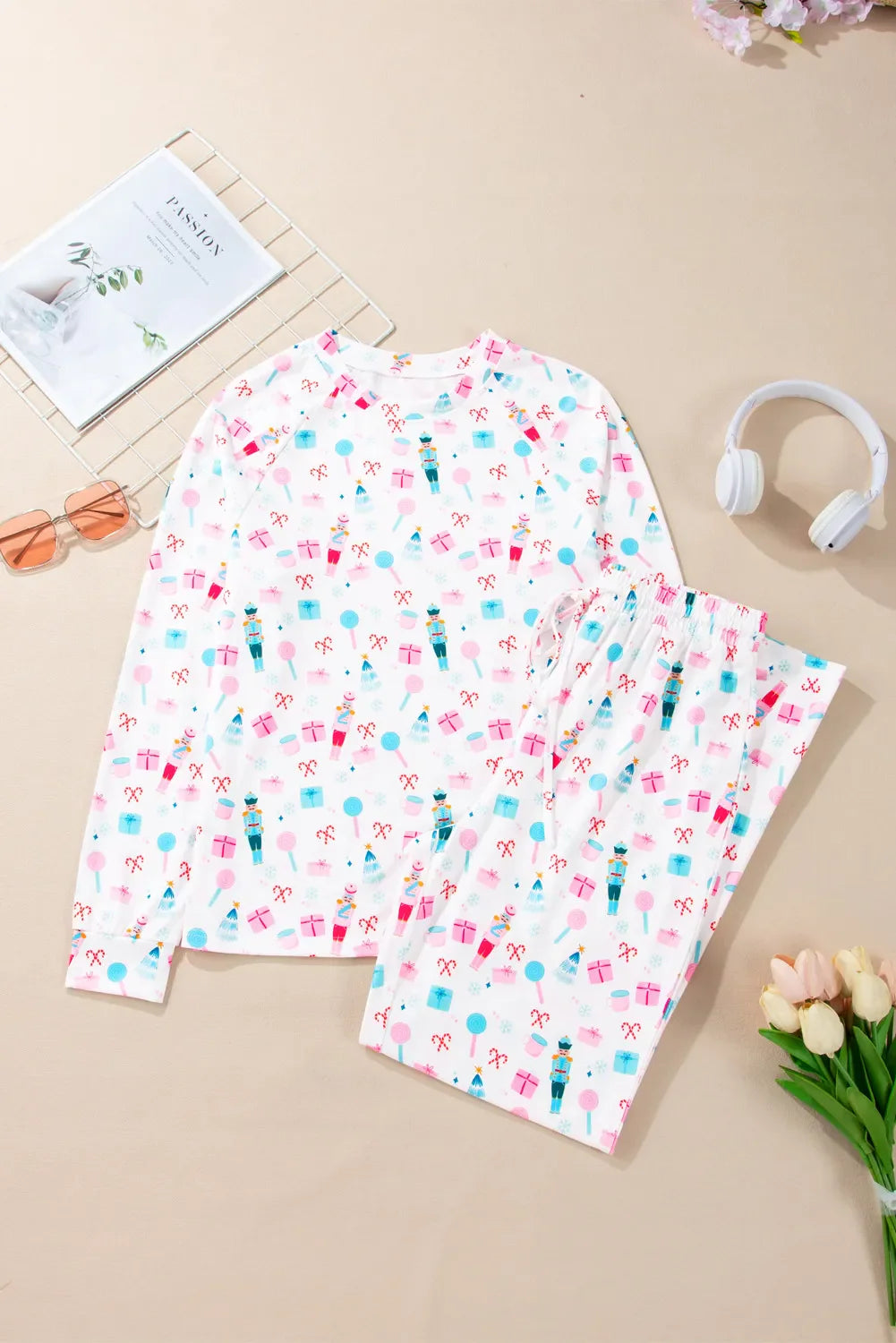 White long sleeve pajama set with nutcracker, candy cane, and gift print.